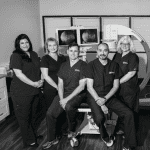 A group of doctors and nurses in front of an mri machine.